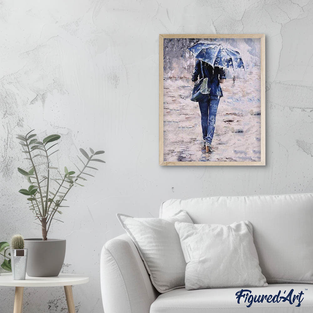 Woman dressed in blue under an umbrella
