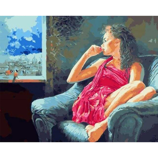 Pensive woman near the window