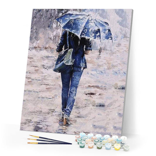 Woman dressed in blue under an umbrella